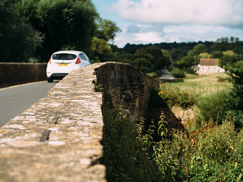 Car travelling over a Bridge in Cotswolds, England