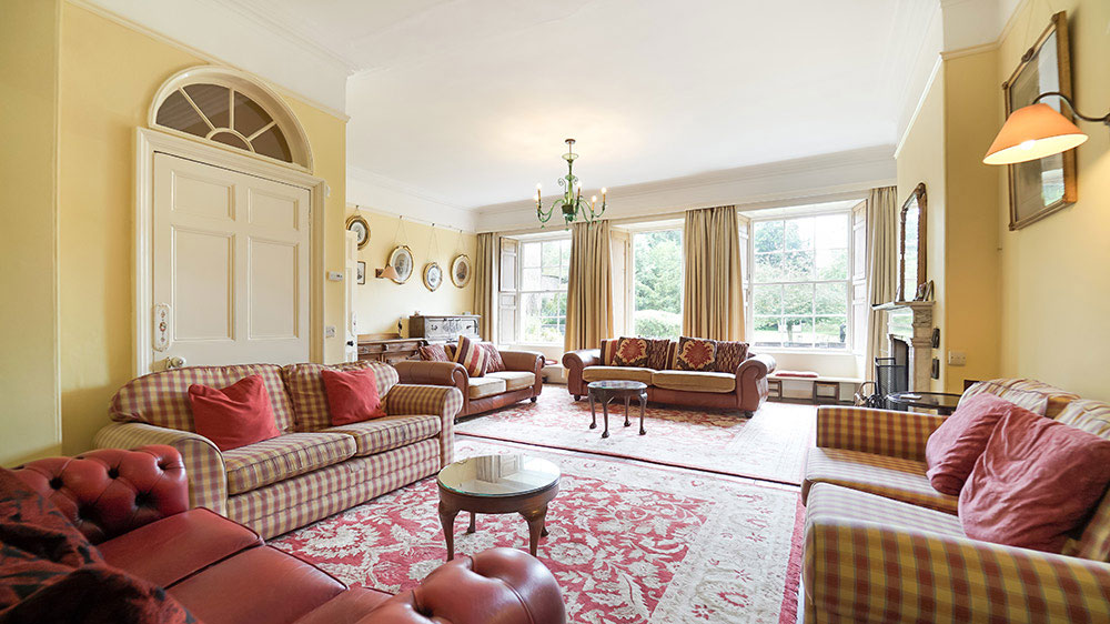 The sitting room at Tone Dale House has plenty of comfortable sofas for a large gathering
