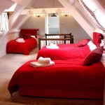 This attic bedroom is ideal for large family gatherings, with 4 single beds for children