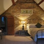 This bedroom at Cotswold Manor has a secret passageway