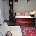 One of the large barn bedrooms with it's own sitting area at Devon Farmhouse in south Devon