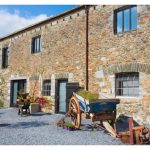 Devon Farmhouse has a charming courtyard area for the barn bedrooms, to give extra accommodation for groups larger than 16