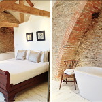 Beams and exposed brickwork create a sophisticated design in this bedroom at Devon Farmhouse