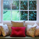 The pretty window seat in the sitting room, with an eclectic mix of cushions.