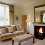 The large sitting room with a roaring log fire and comfortable sofas for relaxing and chatting with friends.