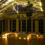 The Orangery is a charming space for a special celebration dinner party with fairy lights and candles glowing