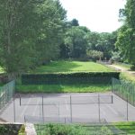 Our party house in Somerset has a tennis court next to the long tree lined driveway.