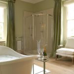 The large en-suite bathroom to Bedroom 1, has a roll top bath and separate shower