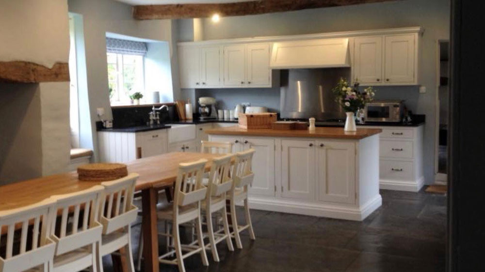 The kitchen is spacious and well equipped for cooking for your big group at Cotswolds Manor.