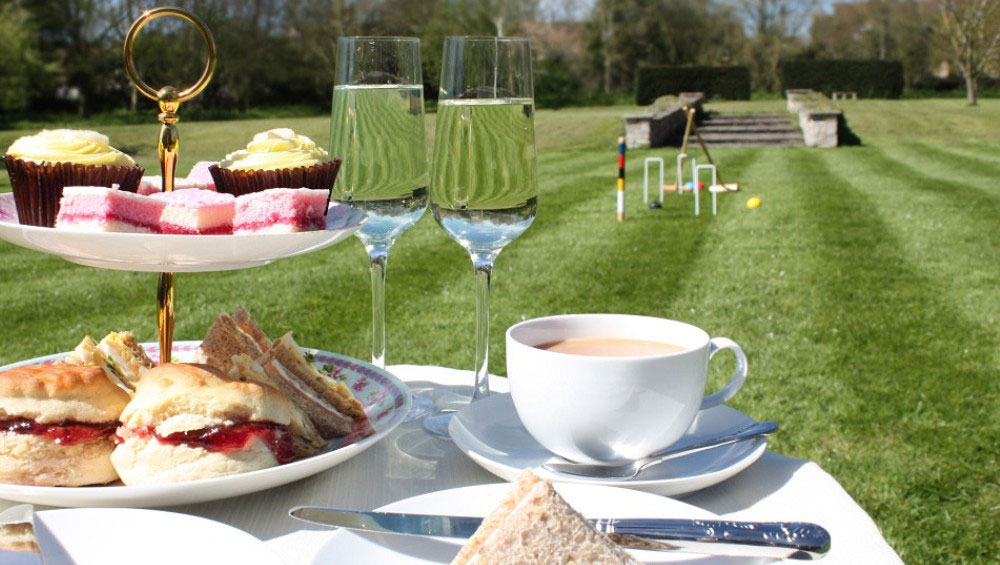 Sumptuous cream teas on the lawn at Cotswold Manor. Contact the Big House Company for recommended local chefs.