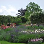 The splendid gardens at this big house to hire have beautiful flower beds and large areas of lawn for children to play.