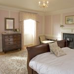 The Buck bedroom has a wooden sleigh bed and lovely antique furniture.