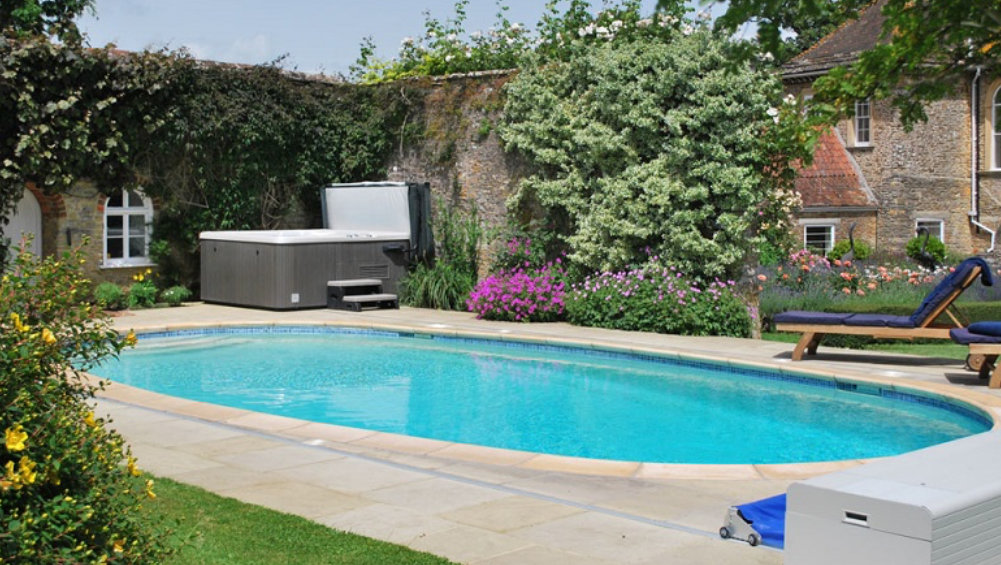 The outdoor heated pool and hot tub at Somerset Manor, available through The Big House Company