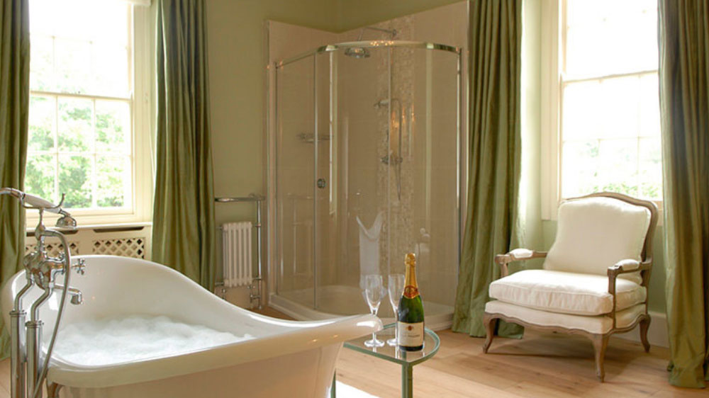 A glamorous, large bathroom at Somerset Manor with roll top bath & shower.