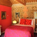 Norfolk Barns - A stunning lipstick red gives this bedroom a cosy feel