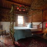 Norfolk Barns - Bedroom 8 with a rustic 4 poster bed and its own ensuite