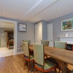 Pretty pale grey walls and a wooden floor in the charming breakfast room at Dorset Lodge