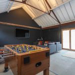 The games room has wide screen tv, table football and pool table