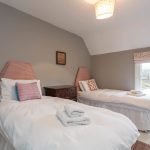 Pretty twin beds in Bedroom 5 at Dorset Lodge
