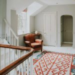 Attractive rugs and beautiful artwork adorn the house