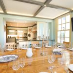 This party house in Somerset has a dining area with mood lighting and a large oak table