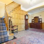 The oak panelled hall with stairs leading to 8 of the 10 bedrooms at Tatham House in Somerset