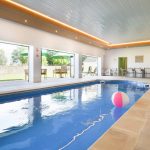 The indoor pool at Tatham House has bi-fold doors opening onto the walled garden and terrace area