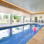 The indoor pool has bi-fold doors opening onto the walled garden and terrace area