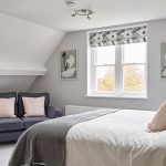 Beautiful textiles and pale paintwork in this bedroom at our big house near Cheltenham.