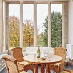 The Sun Room with large windows looking over the gardens.