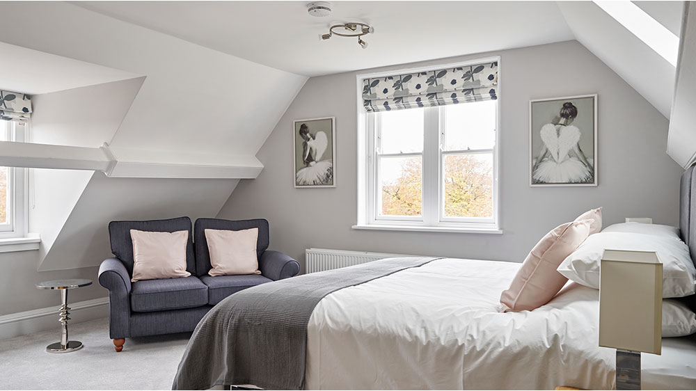 Guests of The Big House Company love the attic bedrooms with its large bed and seating area.