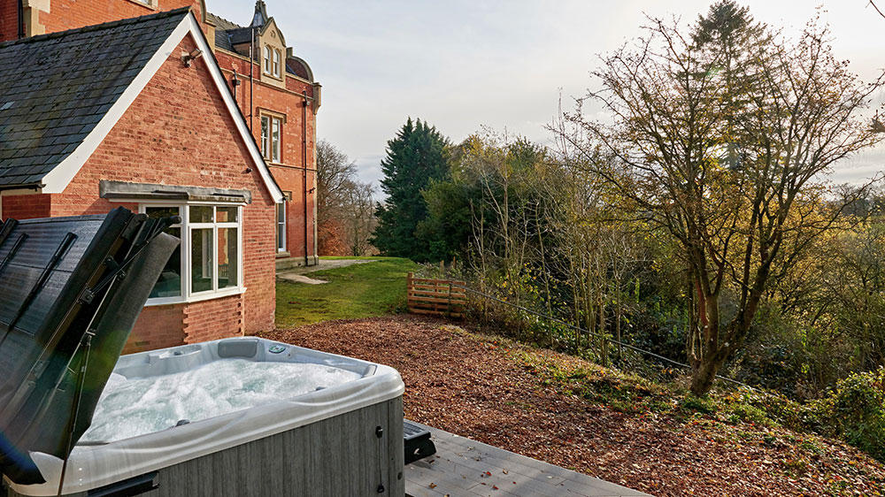 The hot tub is popular at this big house, with its views over the countryside.