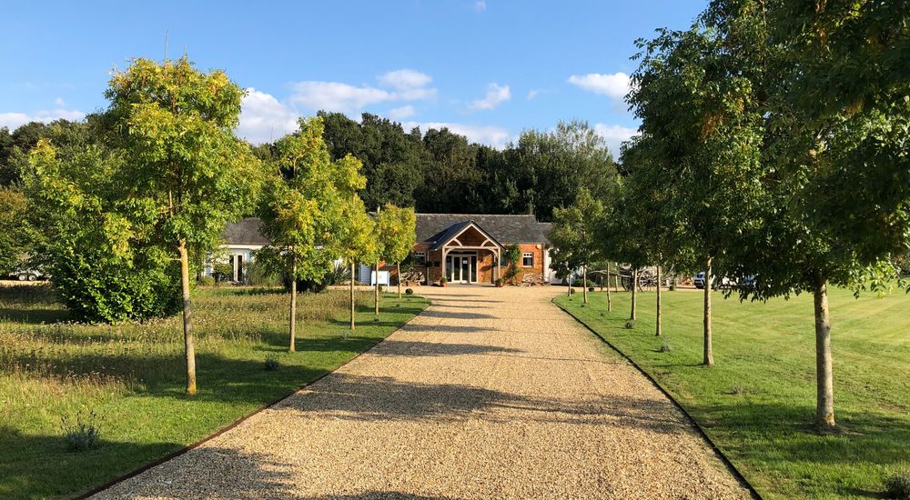 A lovely approach to this Norfolk barn along a tree lined, sweeping driveway