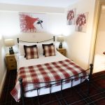 A cosy ground floor bedroom with a double bed and ensuite