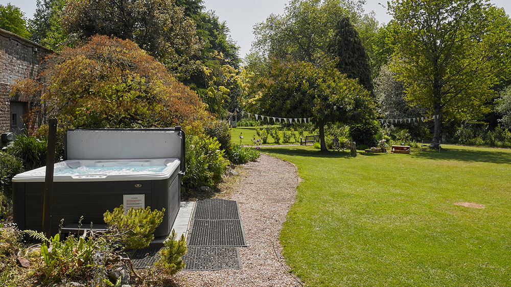 Tone Dale House - relax in the large hot tub and enjoy looking over the delightful garden