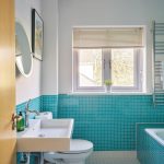 A sleek family bathroom with stunning turquoise tiles