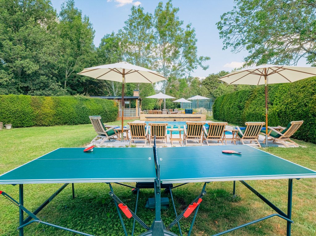 Poolside dining area with countryside backdrop