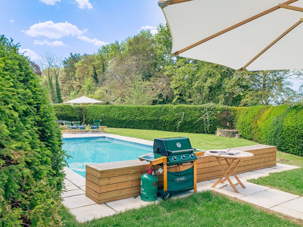 Luxury pool with seating area and umbrellas
